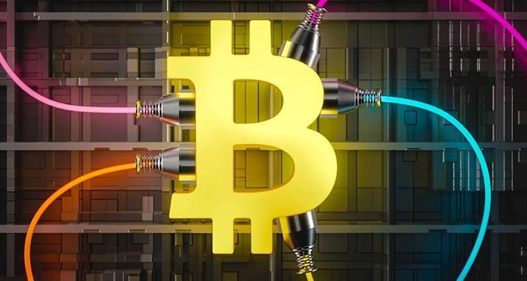 A glowing golden Bitcoin symbol centered against a backdrop of computer circuitry. Multiple colored cables, representing energy, plug into the Bitcoin symbol, highlighting the concept of ASIC Miner Energy Consumption.